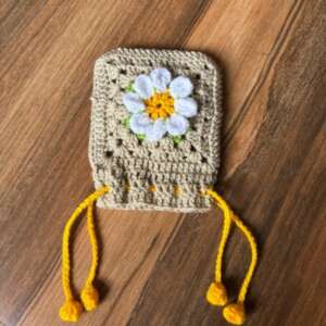 Hand-crocheted mini daisy drawstring pouch